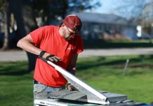Shane David Roofing crew preparing roofing materials — TAMKO shingles being cut for installation